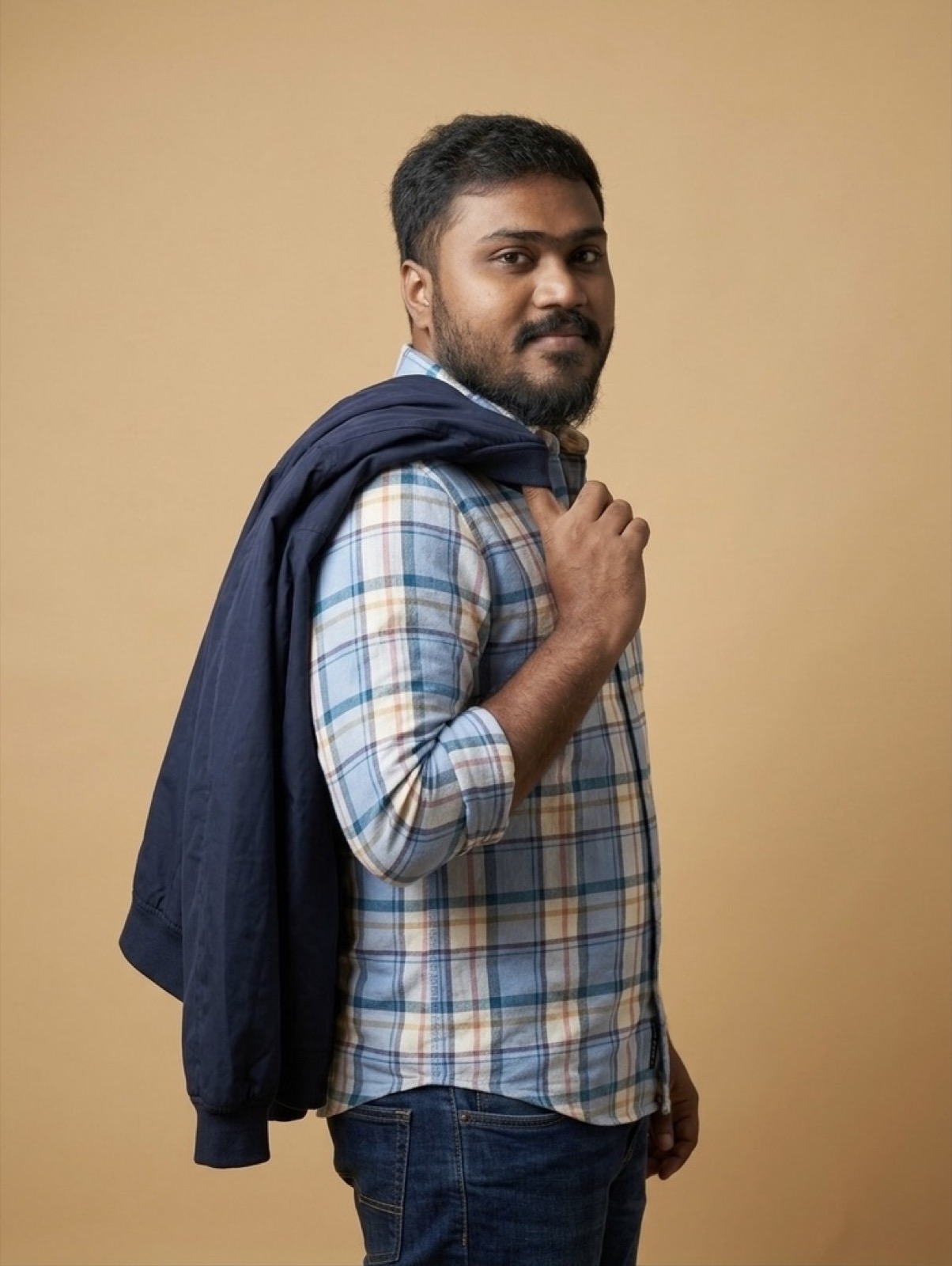 thrinadhsai standing author photo with jacket over shoulder